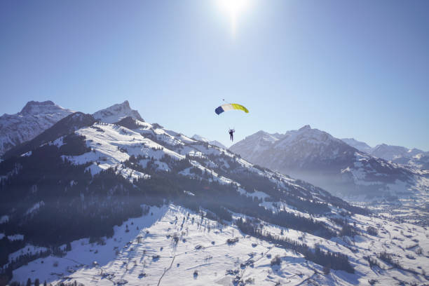 istock Female paraglider glides through clear skies 1378260239