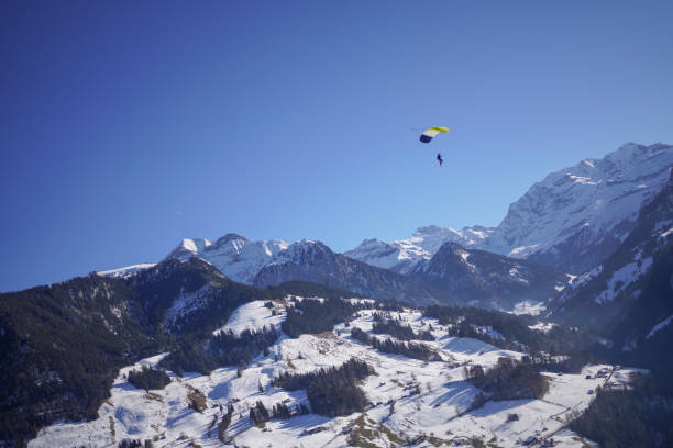 istock Female paraglider glides through clear skies 1378261035