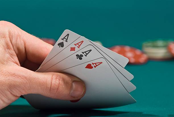 istock playing cards in a hand on  green felt 137827517