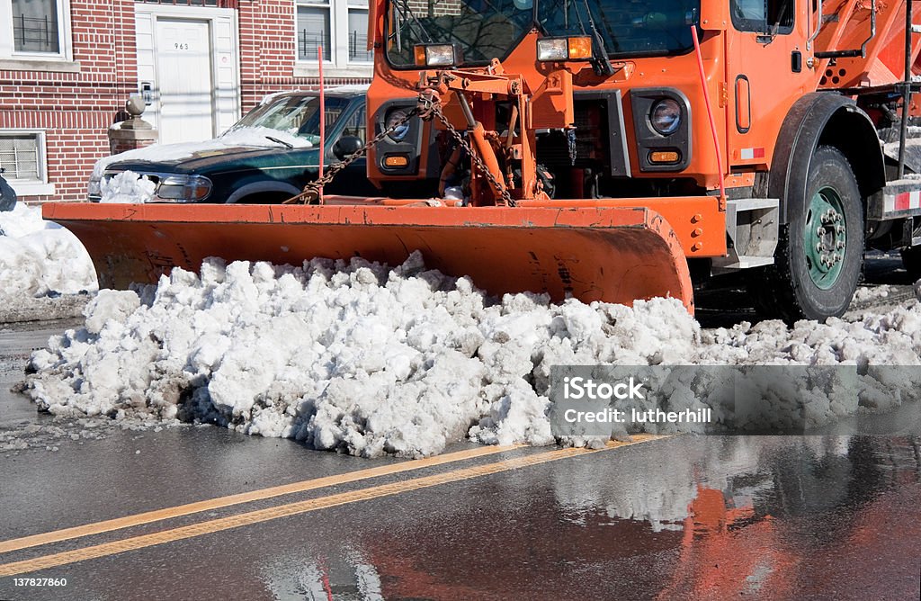 snow plow clearing streets in a city city street being plowed after a big snow storm Blizzard Stock Photo