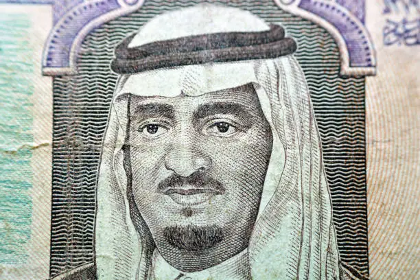 A portrait of King Fahd bin Abdulaziz Al Saud, former king of Saudi Arabia from the obverse side of 5 five Saudi riyals banknote currency 1983, Old Saudi money, vintage retro
