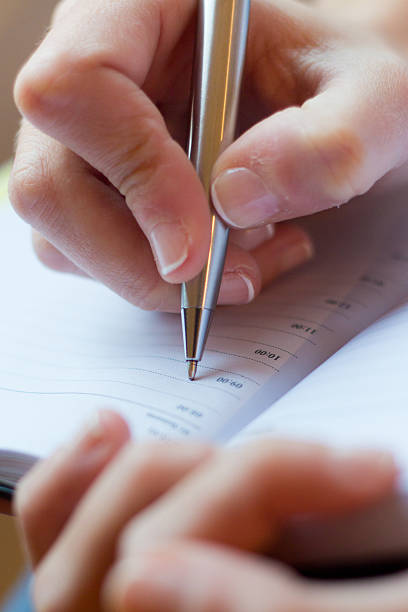 istock Woman hand writes on a paper 137829643