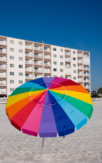 Beach umbrella with building in background
