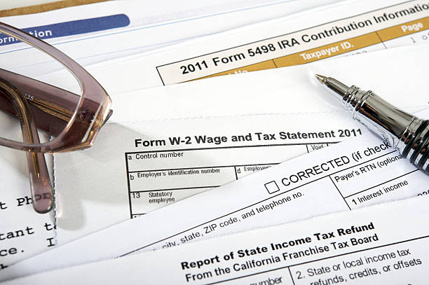 Tax forms with pen and glasses on top stock photo