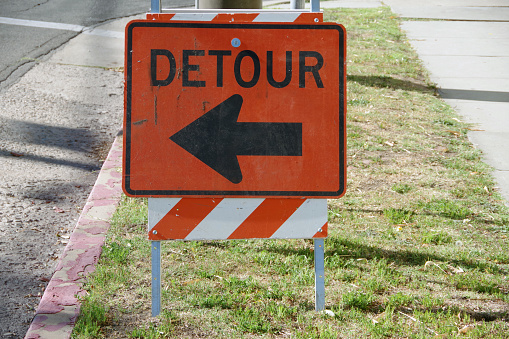 Temporary DETOUR sign with an arrow pointing to the left