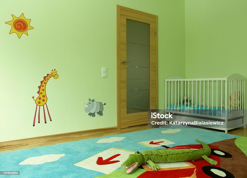 Baby's room with a cot Children's jungle themed bedroom with a baby cot. Child Stock Photo