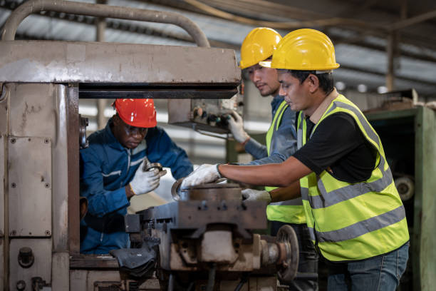 istock Professional asian workers and african man factory working at steel heavy machine. engineering training staff. Concept Engineer Operating and control in Factory with safety. 1378389937