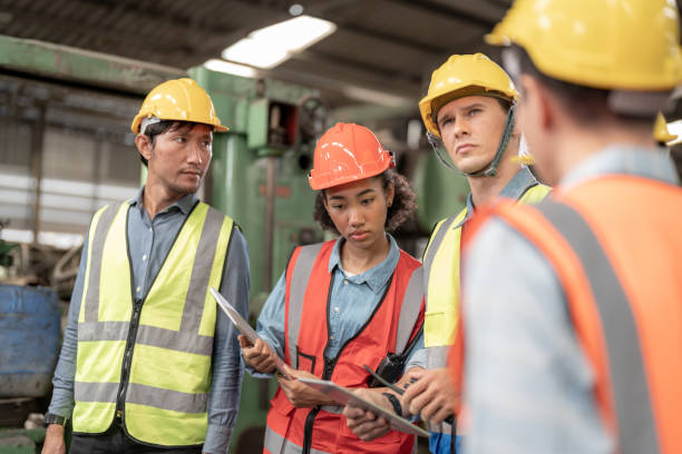 istock Professional engineering workers walk and check in warehouse factory. Manager discuss inspection report for internal audit. Quality assurance for manufacturing. Concept Engineer Operating. 1378391490