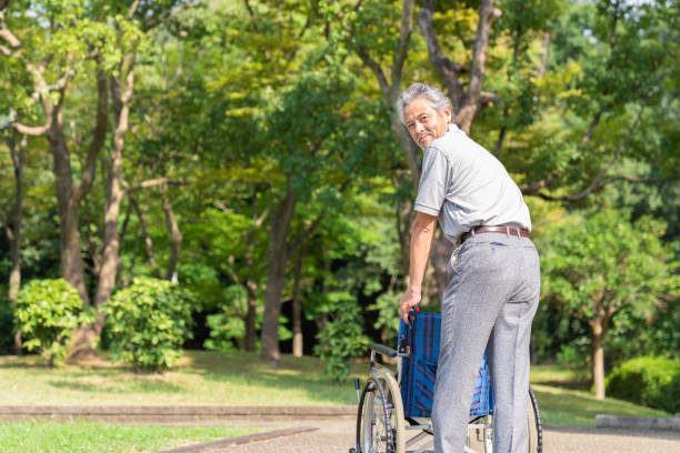 Senior man sitting in his wheelchair outside