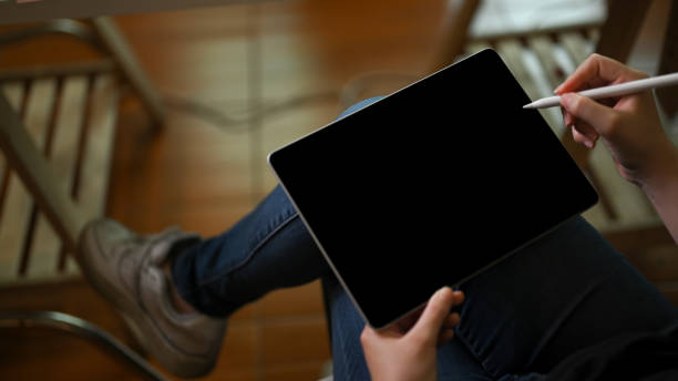 istock Female remote working at the coffee shop, using digital portable tablet. 1378426773