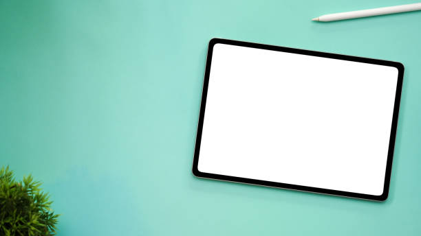 istock Workspace with tablet mockup and copy space on green background. 1378427313