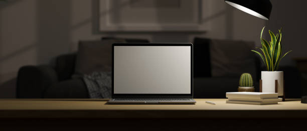 istock Modern dark home workspace table in living room with portable laptop 1378429411