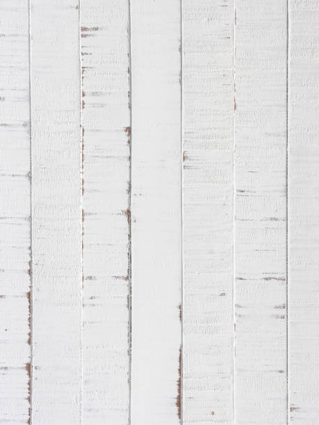 istock Old worn, weathered, white painted vertical wood paneling background. 1378442979