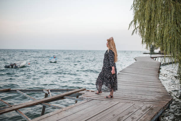 istock Plus size model standing on the pier in old town 1378453971