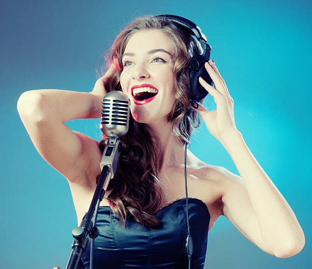 istock Woman Singing into Microphone 137845756
