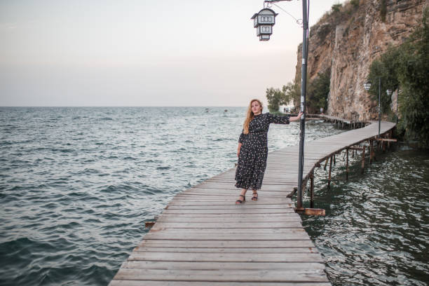 istock Blonde plus size model walking along the pier 1378461211