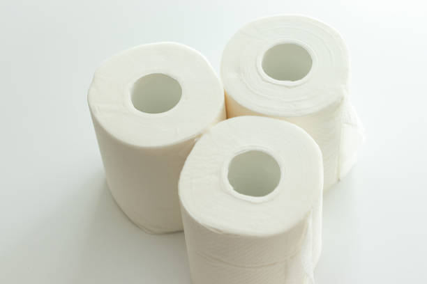 istock Three toilet paper rolls on the white table 1378470423
