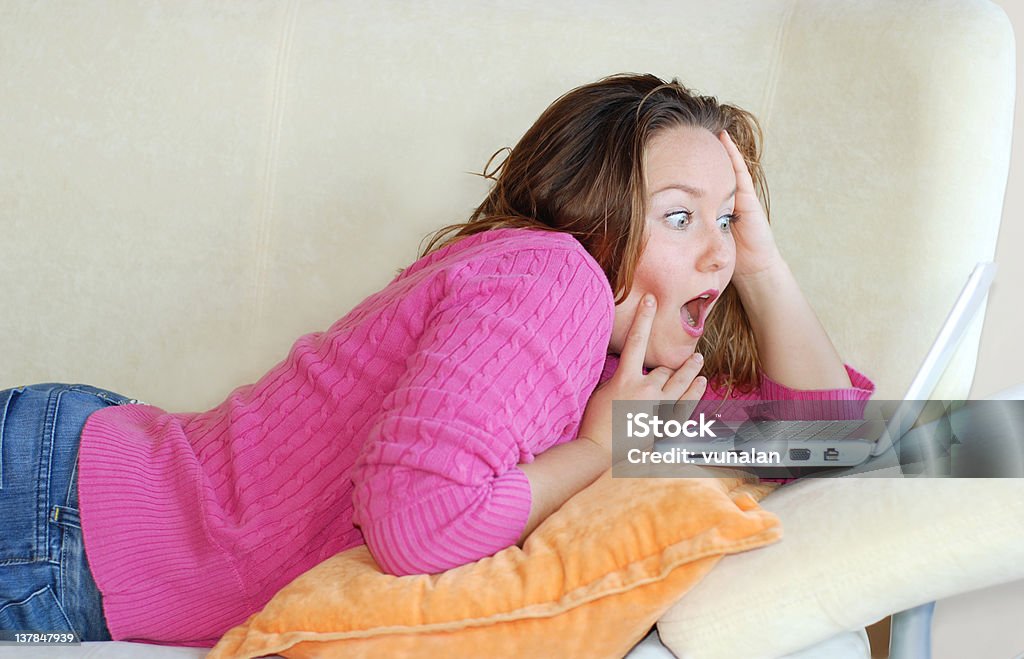 Shocking Girl with shocked expression on laptop PC. 20-29 Years Stock Photo