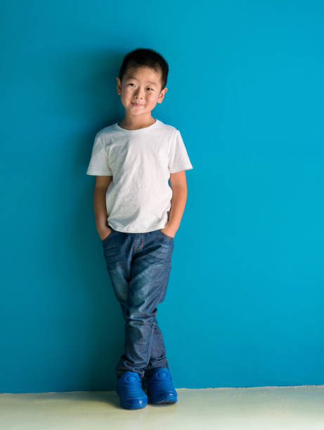 istock A cute boy standing in front of the blue wall 1378500260