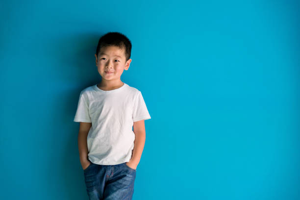 istock A cute boy standing in front of the blue wall 1378500775