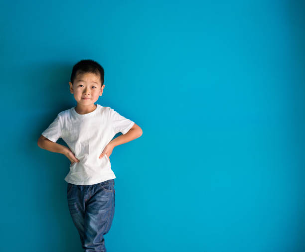 istock A cute boy standing in front of the blue wall 1378500777