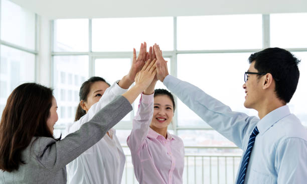 istock Group of business people giving high five 1378501312