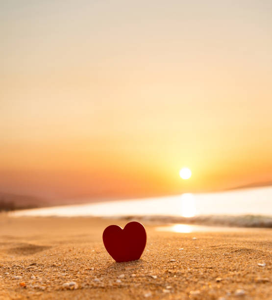 istock Red heart shape on the beach at sunset 1378503887