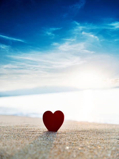 istock Single red heart shape on the beach 1378503888
