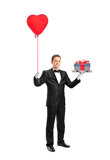 istock Waiter holding a red heart shaped balloon and gift 137850904
