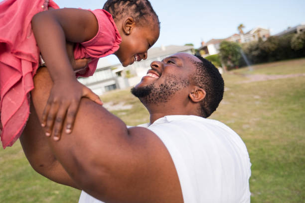 istock Father plays with his daughter at the park 1378509619