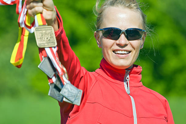 Happy woman runner, multi-medalist Happy woman winner, the multi medalist. multi medal stock pictures, royalty-free photos & images