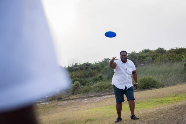 istock Father throws a frisbee to his son 1378510739