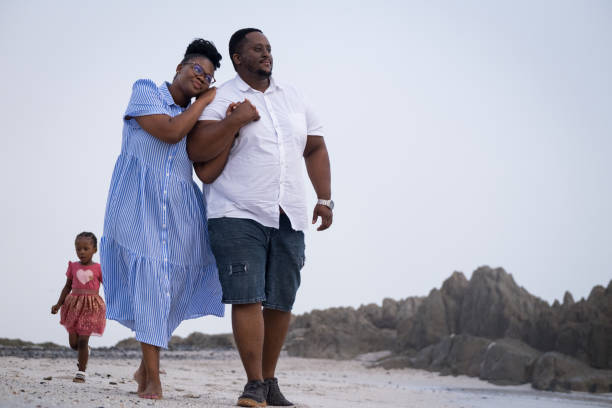 istock Parents enjoy time at the beach with their children 1378510879