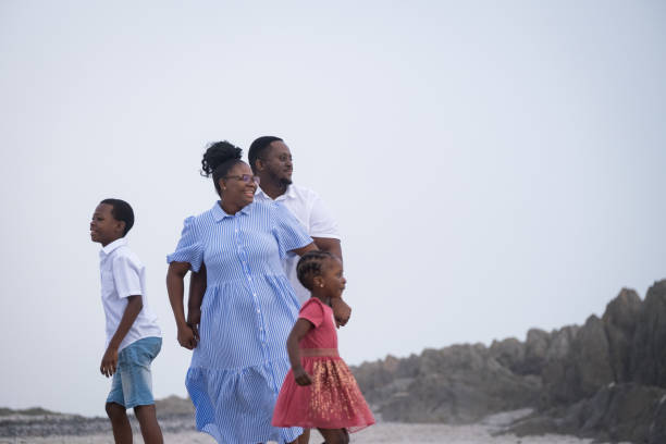 istock Parents enjoy time at the beach with their children 1378510896