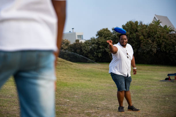 istock Father throws a frisbee to his son 1378515209