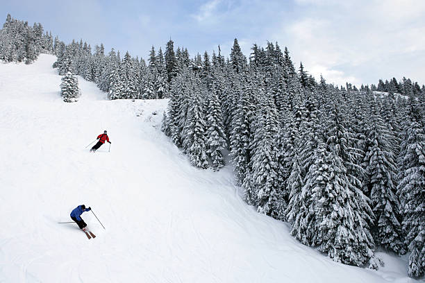 two people skiing on steep black diamond trail (XL)