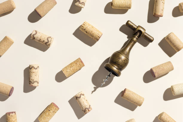 Pattern with wine corks and retro bottle opener from white and red wine on beige pastel background with shadow at sunlight. Trend layout with bottle cap wooden cork and corkscrew, top view table Pattern with wine corks and retro bottle opener from white and red wine on beige pastel color background with shadow at sunlight. Trend layout with bottle cap wooden cork and corkscrew, top view table cork stopper stock pictures, royalty-free photos & images