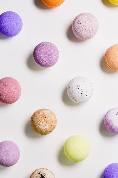 istock Pattern with colorful bath bombs on white paper background. Bathing balls with essential oil for relaxation and aromatherapy. Body care natural products. Colored cosmetic bomb for spa 1378555438