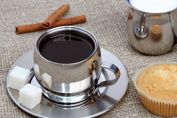 istock Cup of black coffee with muffin, milk and cinnamon 137858116