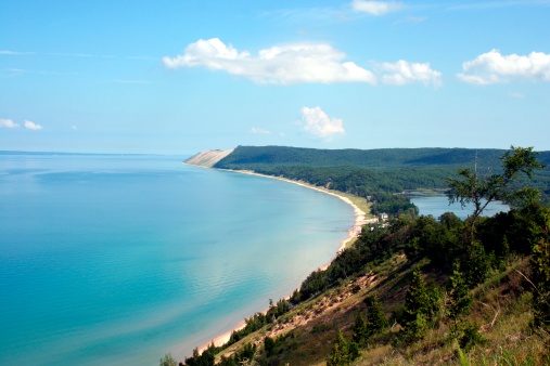 The Log Slide overlook located in Pictured Rocks National Lakeshore showcases the impressive size of the Grand Sable Dunes which tower 200 feet over the waters of Lake Superior. 