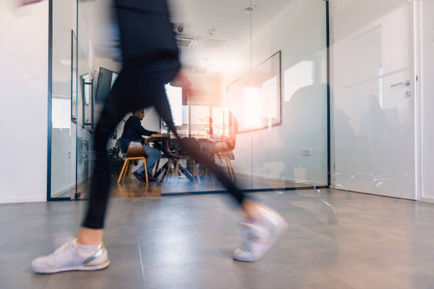 istock Young business women walking through the office corridor 1378590497