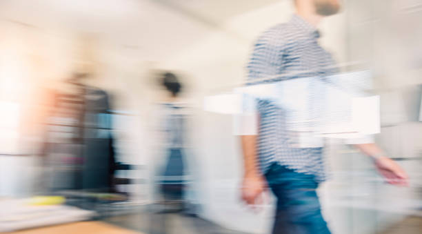 Business people walking through the office corridor