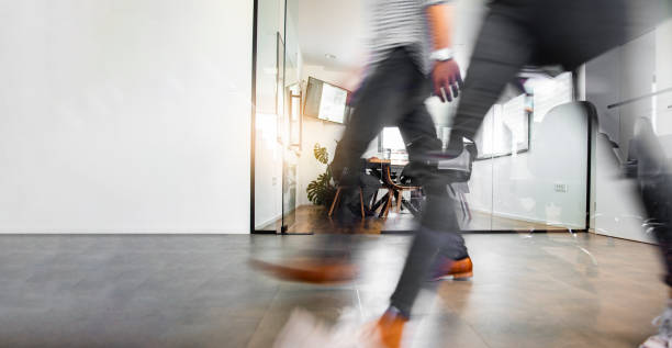 Business people walking through the office corridor