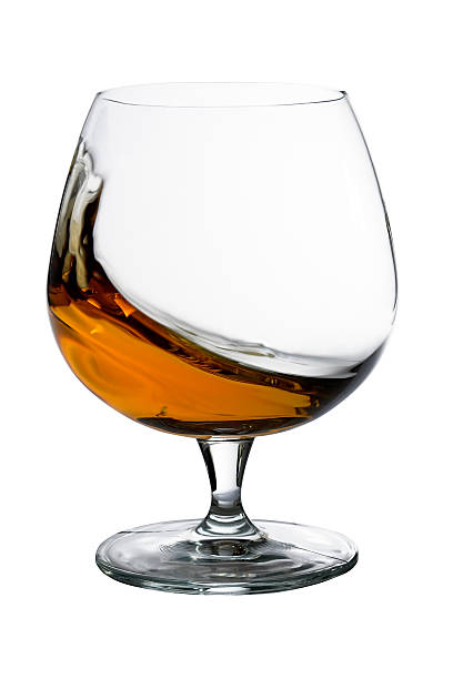 Brandy - Cogniac i in the motion One Glass of Brandy. Brandy in motion. Isolate. White Background cognac stock pictures, royalty-free photos & images