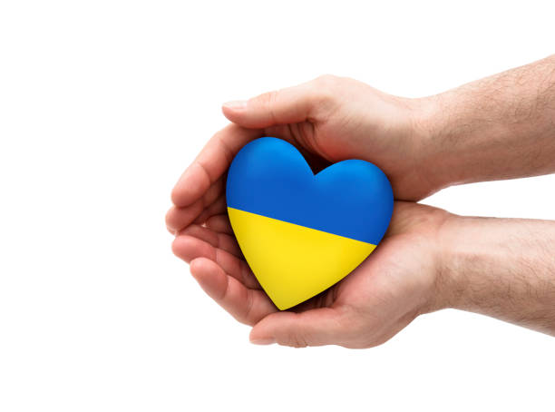 istock Ukrainian heart in hands isolated on white background with clipping path 1378643903