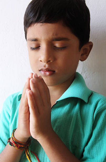 istock Indian Little Boy Praying 137864552