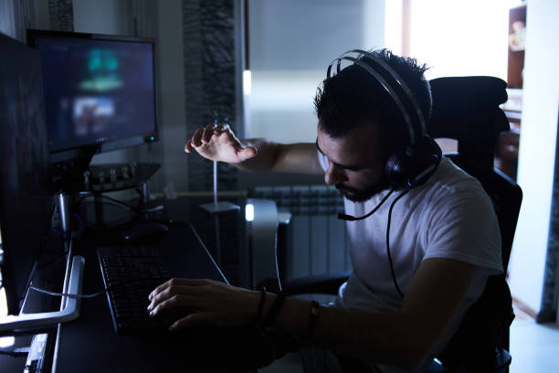 istock a young 30-year-old gamer is sitting at a computer, playing computer games, nervous, angry, worried.selective focus with low depth of focus 1378674793