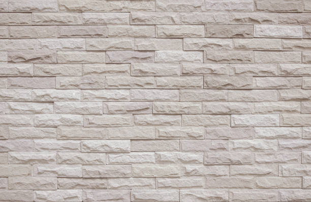 istock Cream and beige brick wall texture background. Brickwork and stonework flooring interior rock old pattern clean concrete grid uneven bricks office design. Background of old vintage brick wall backdrop 1378675383