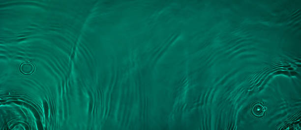 istock transparent dark green colored clear calm water surface texture 1378680149