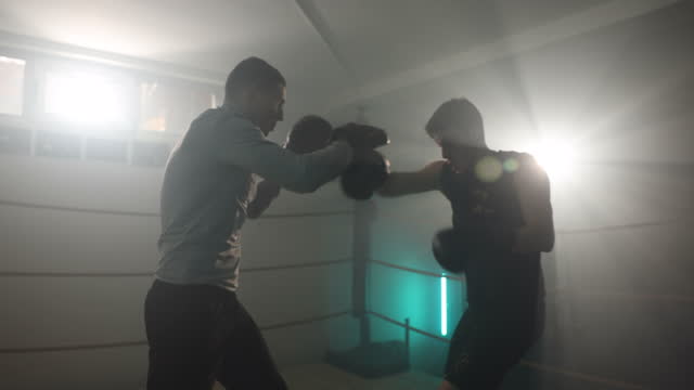 Man training boxing with trainer